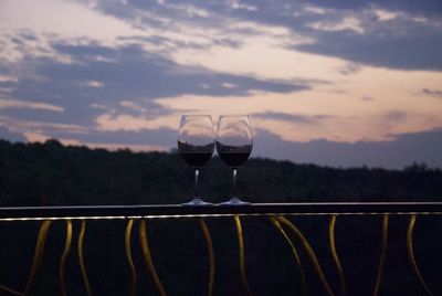Close-up of wine glass against railing