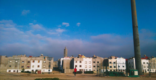 Buildings in city against blue sky