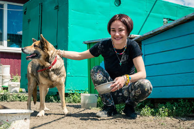 Dog at the shelter. animal shelter volunteer takes care of dogs. lonely dogs in cage with volunteer.