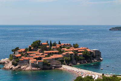 Scenic view of sea and buildings against sky