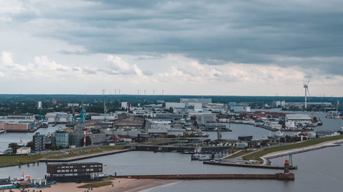 High angle view of buildings by sea against sky