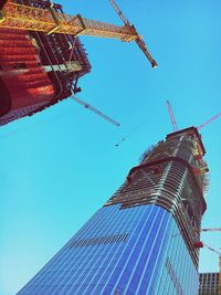 Low angle view of skyscraper against clear blue sky