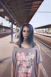 Portrait of young woman standing outdoors