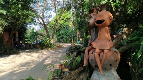 Statue against trees