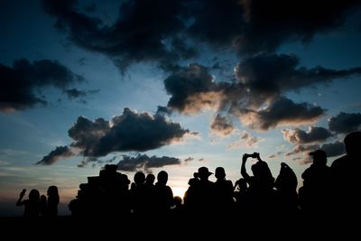 Silhouette people against sky during sunset