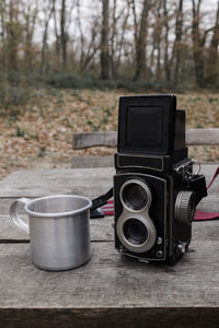 Close-up of camera on table in forest