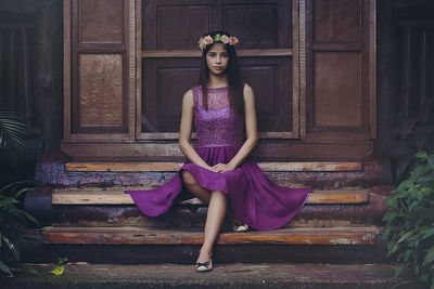 Portrait of young woman sitting on steps