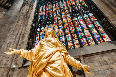 Low angle view of statue against temple building