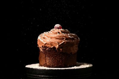 Close-up of chocolate cake against black background