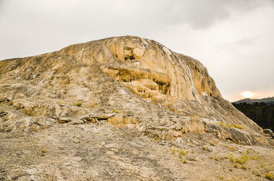 Low angle view of rock formations against sky