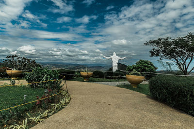 Statue by trees against sky