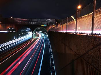 High angle view of light trails on bridge at night