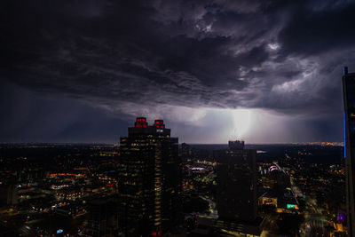 Illuminated cityscape against sky at night