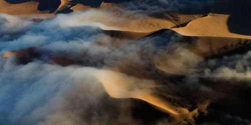 Smoke emitting from chimney against sky