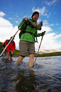 Group of hikers crossing river on the laugavegur hiking trail