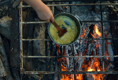 Close-up of man preparing food on barbecue grill