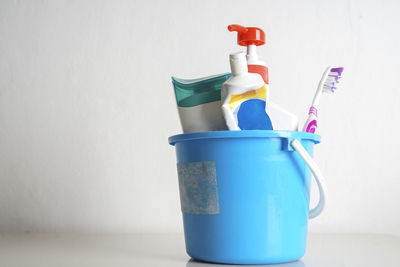 Close-up of bottle against blue wall