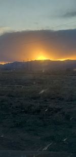 Scenic view of field against sky during sunset