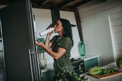 Side view of woman preparing food at home