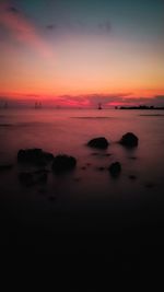 Scenic view of sea against romantic sky at sunset