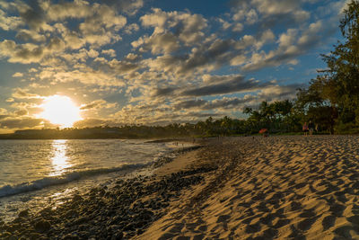 Scenic view of beach against sky during sunset