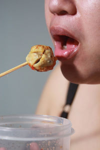 Close-up of young woman eating food