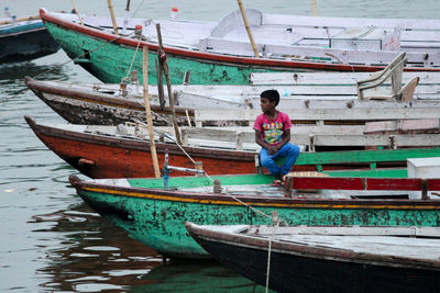 Full length of man on boat moored at sea