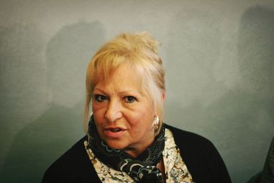 Close-up portrait of a mature woman over white background