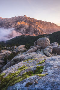 Surface level of rocks on mountain against sky