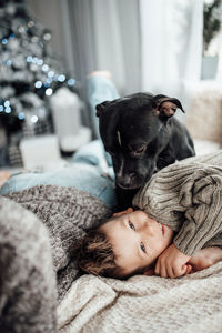 Portrait of cute boy lying on bed