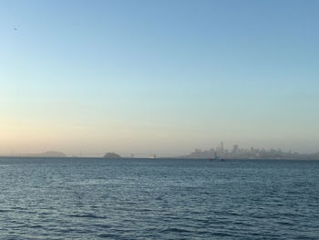 Scenic view of sea against clear sky during sunset