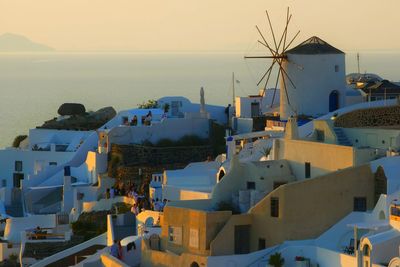 High angle view of townscape by sea against sky