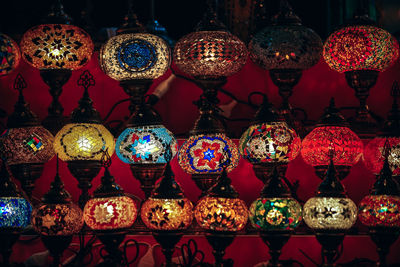Illuminated lanterns hanging at market stall