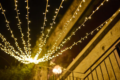 Low angle view of illuminated lights on ceiling