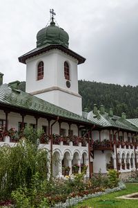 Church by building against sky