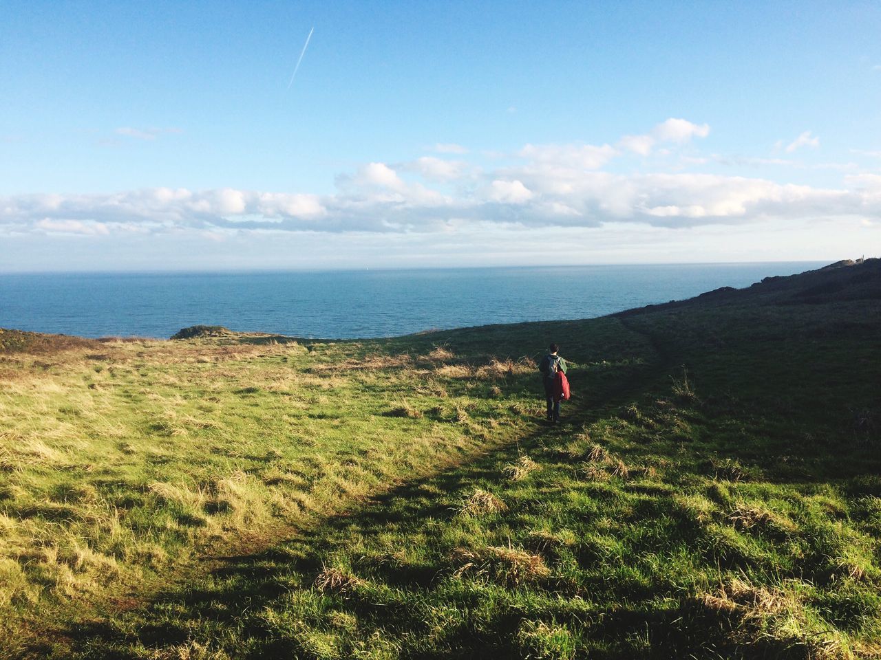 beauty in nature, sea, nature, lifestyles, sky, leisure activity, scenics, real people, one person, tranquility, tranquil scene, horizon over water, outdoors, day, men, grass, water, one man only, people