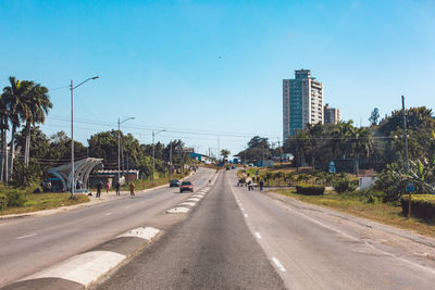 Road by city against sky