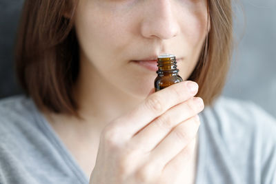 Young and beautiful caucasian women sniff a tube of aromatic person