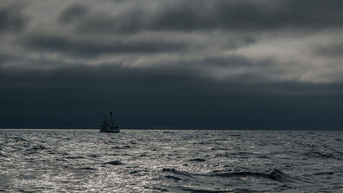 Scenic view of sea against cloudy sky