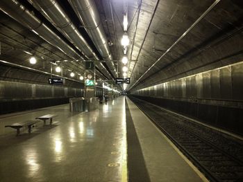 Empty illuminated subway station at night