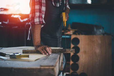 Cropped hand of man working at workshop