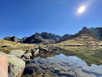 Scenic view of snowcapped mountains against clear blue sky