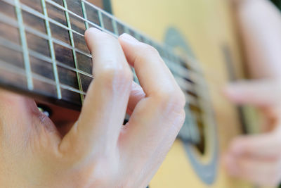 Cropped image of man playing guitar