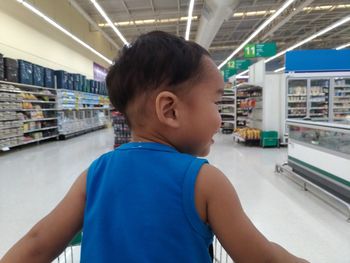 Rear view of boy looking at camera