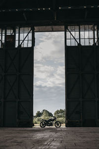 Motorcycle parked outside building against sky
