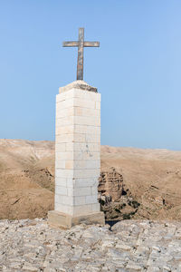 Low angle view of cross against clear sky