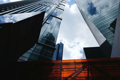 Low angle view of buildings against cloudy sky