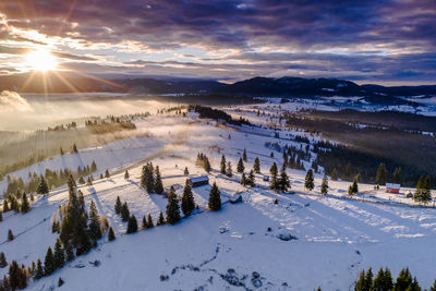 Scenic view of snow covered landscape against sky