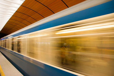 Blurred motion of train at railroad station