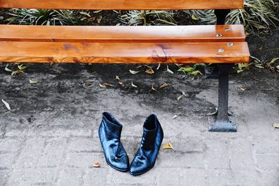 High angle view of shoes on empty bench